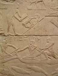 Relief depicting a man tending a new-born piglet and men in papyrus boats, from the Mastaba of Kagemni, Old Kingdom