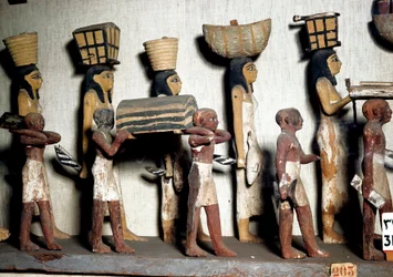 Egyptian Antiquity: A Sculpted Group of Painted Wood Representing Servants Bearing Offerings to the Deceased