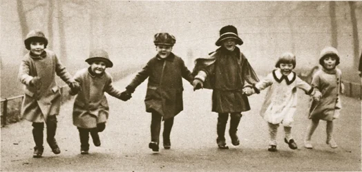 A line of well-dressed children running in Hyde Park, from Wonderful London, published 1926-27