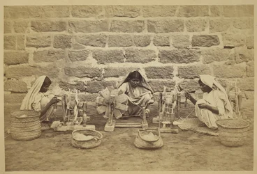 Female prisoners winding cotton on spinning wheels in Karachi Prison. Photographer: Michie and Company c. 1873. Archaeological Survey of India Collections: India Office Series (Volume 52)