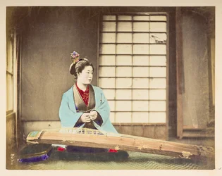 Singing girls [Japan], Studio portrait of a Japanese woman, seated with a stringed instrument (a kind of zither) resting on the floor in front of her