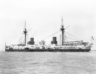 View of the ironclad battleship HMS Inflexible (launched 1876) pictured after conversion to military rig in 1885