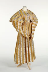 Muslin dress with abstract mauve pattern printed within yellow and white vertical stripe design, c.1820-30