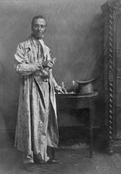 Photograph of a grey morning coat of flowered chintz with nankeen trousers, from Old English Costumes: A sequence of fashions through the 18th and 19th Centuries