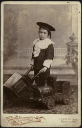 Portrait of a Young Boy Posing with a Handcart