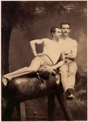 Portrait of two gymnasts posing on a pommel horse c. 1899