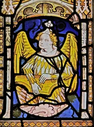 The East window depicting a musician angel with zither