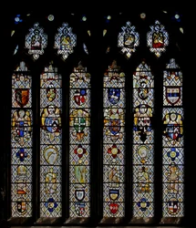 Window St Nectan Chapel Sw depicting angels with shields of arms; reset angels, heads and roundels. the four Evangelists symbols