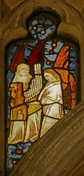 Window depicting musician angels, one with a portative organ