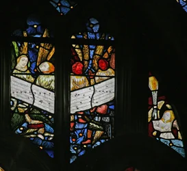 Window depicting the angelic choir singing; angel censing