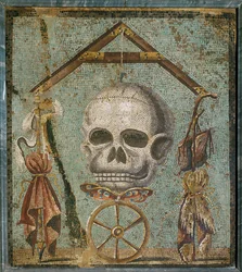 Skull, symbol of death, surrounded by symbolic objects: a butterfly for flying time, a wheel of fortune