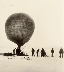 A view of the cow-gut balloon being inflated with hydrogen on the ice. From an album by Sir Ernest Henry Shackleton entitled National Antarctic Expedition (1901-1903)