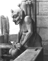 Gargoyle from the balustrade of the Grande Galerie, devil holding a toad, replica of a 12th century original