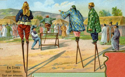 Korean women on stilts playing a game of jumping over hurdles, 1904