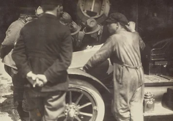Men Grouped Around the Hood of a Car