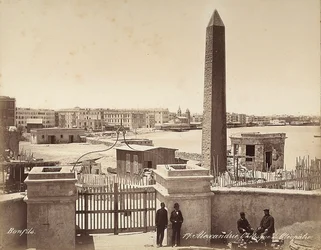 Alexandria, Egypt: the Obelisk of Cleopatra, with four men posing for the photograph
