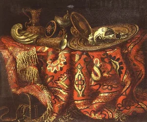 A nautilus cup, a paten, ewers and a gilt dish on a carpet draped over a ledge