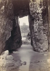 View Through Rocks of Tower On Hill