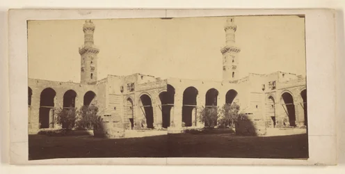 View of Building with High Tower, Tomb in Courtyard