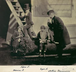Hermine, Alfons and Eugen Antoine and Mathias Höusermann on a fallen tree, 1850s-60s