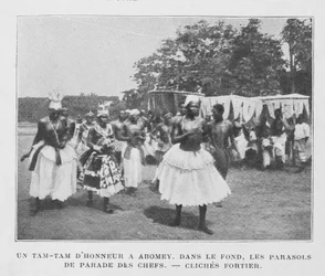 A Tam-Tam of Honour in Abomey with Parasols of the Chiefs in the Background