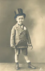 Boy in Double-Breasted Suit, Wearing a Top Hat and Holding a Cane