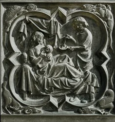 Adam preparing food as Eve, in bed, nurses a child