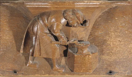 Carving depicting a coppersmith, from a choir stall
