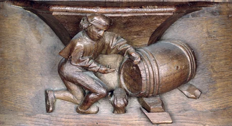 Carving depicting a man putting a tap on a barrel, from a choir stall from the Abbey of St. Lucien in Beauvais