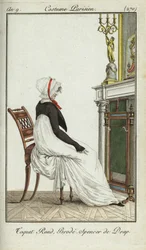 Fashionable woman sitting in front of a fireplace