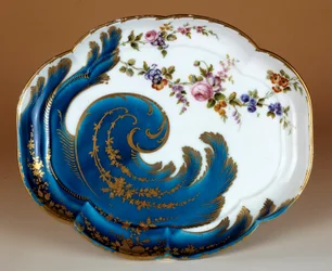 Plate with soft porcelain volutes made in the manufacture of Vincennes. 1755 Paris. Louvre Museum