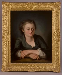 Portrait of a young girl, wearing a green dress and white chemise, seated before a table