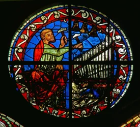 Rosette window depicting an organ and bells