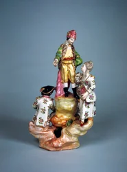 Statuette of four persons grouped on a rockery