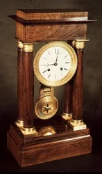 Table clock, polished wood pillars and entablature, French, First Empire period, early 19th century