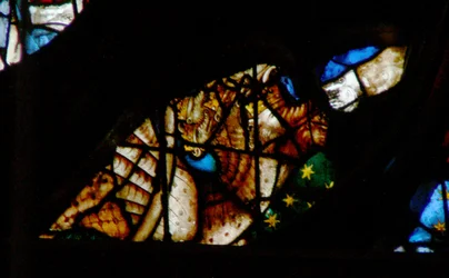 The west rose window depicting a scene from the Book of Revelation: Dragon with seven heads and ten horns and a third part of the stars