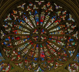 Window, the north rose window, depicting the Coronation of the Virgin in the two uppermost openings, surrounded by angels carrying musical instruments and the Instruments of the Passion