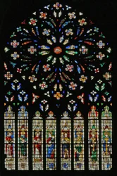 Window w237, the west rose window, depicting the Lamb of the Apocalypse at the center surrounded by 12 angel musicians; coats of arms that include Montmorency-Laval, Bertrand Duguesclin and Oli
