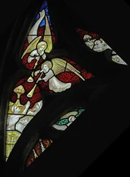 Window depicting musician angels with trumpets at Last Judgement