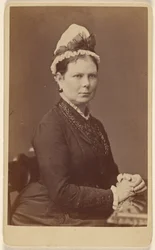 Unidentified Woman Wearing a Bonnet with a Bow, Seated with Hands Together