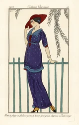 Woman in beach dress of foulard decorated with large dots, red suede hat