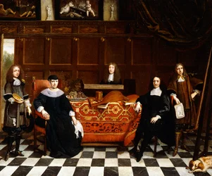 A Group Portrait of a Family seated around a Table draped with a Carpet