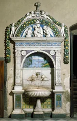 Decorated fountain with a high relief in marble and terracotta by Giovanni della Robbia. Sacristy of Santa Maria Novella, Florence