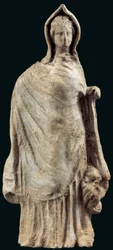 Figurine of a woman wearing a chiton and a himation covering her head, possibly from Myrina, Asia Minor, 250-200 BC