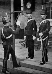 Striking the Gong at the Main Gate of the Aldershot Cavalry Barracks, Hampshire