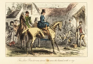 Huntsmen and women watch the fox-hounds let out of a pen before a hunt