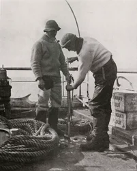 Dr. Wilson and Dr. Atkinson Loading The Harpoon Gun