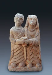 Ancient art: couple bringing an offering. Stone sculpture, 3rd century BC. National Archaeological Museum of Madrid.