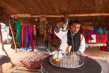A local serving mint tea at Erg Chebbi in the desert near Merzouga, Morocco (photo)