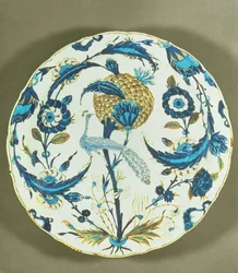 Iznik dish painted with a peacock perched among flowers, Turkey, c.1550-55